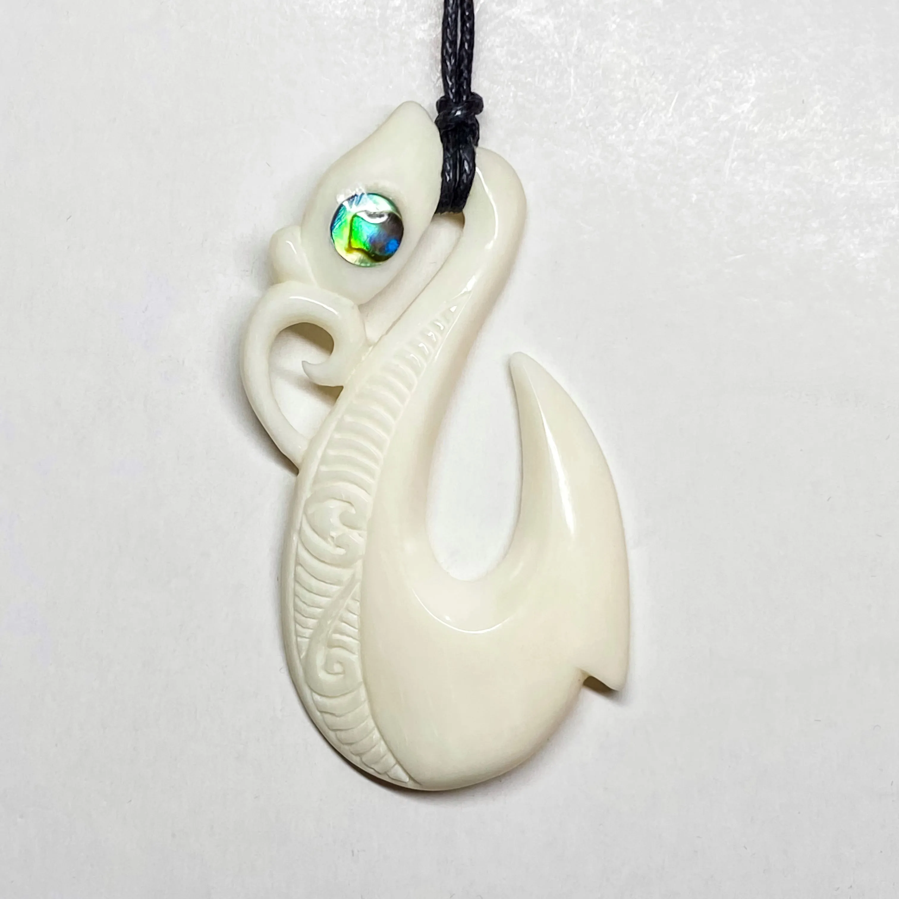 Handcarved Fish Hook Bone Carving Pendant w Paua Eye - Manaia